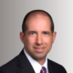 George Koutsaftes as Chief Executive Officer